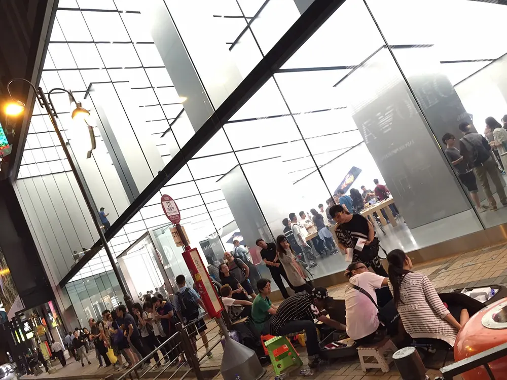 L'image du jour : des vendeurs d'iPhone devant les Apple Store d'Hong Kong